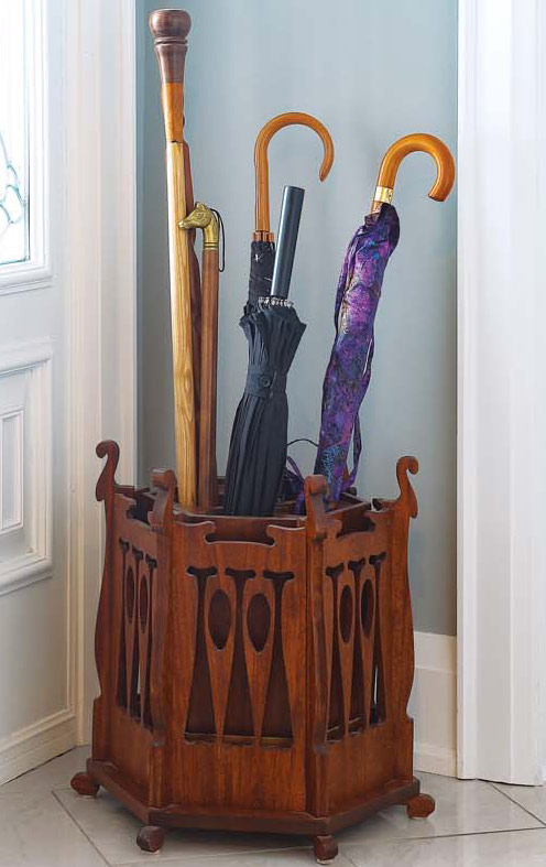 A decorative umbrella stand holding an array of umbrellas and canes.